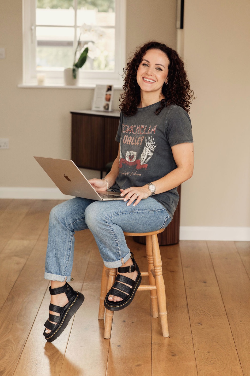 Kayleigh working on the business side of her studio with her laptop