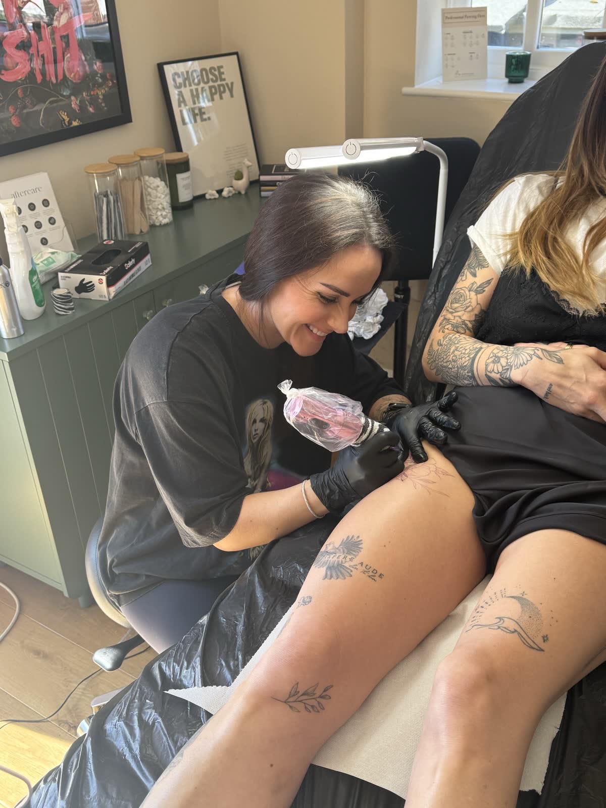 Kayleigh working on a fine line piece