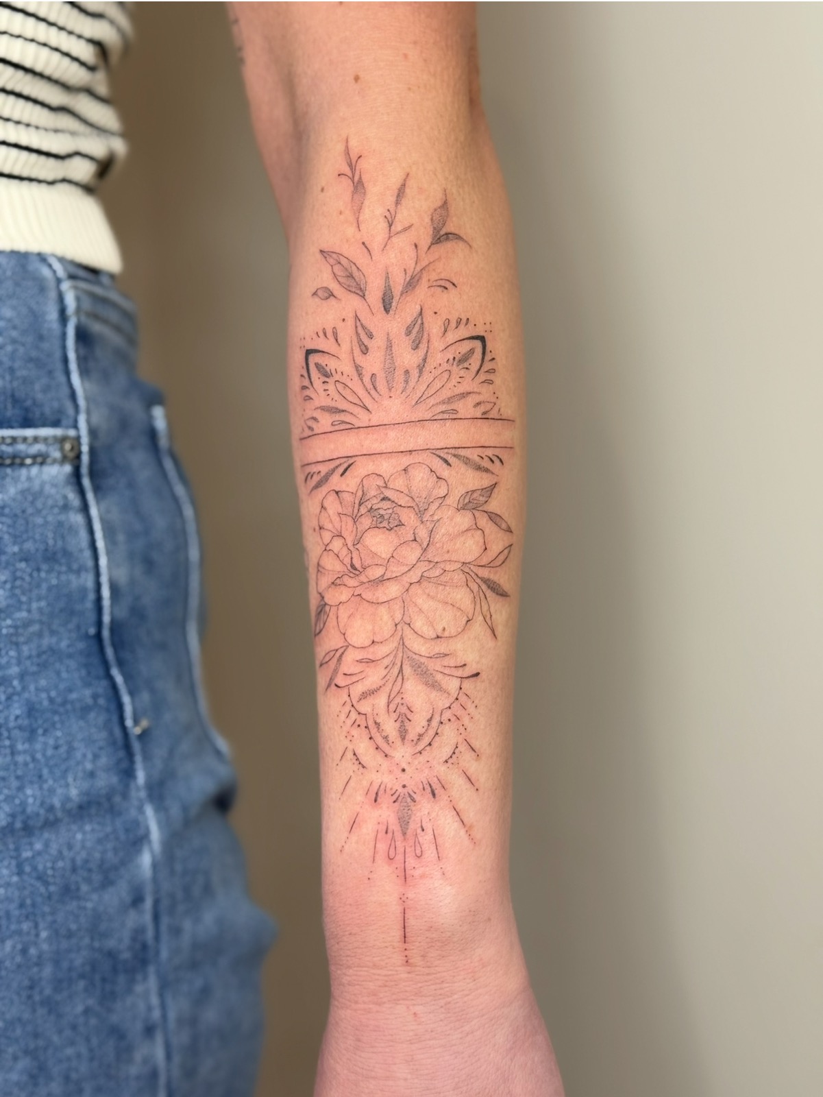 A delicate fine line botanical tattoo, the style taught to PMU artists at Petite Ink