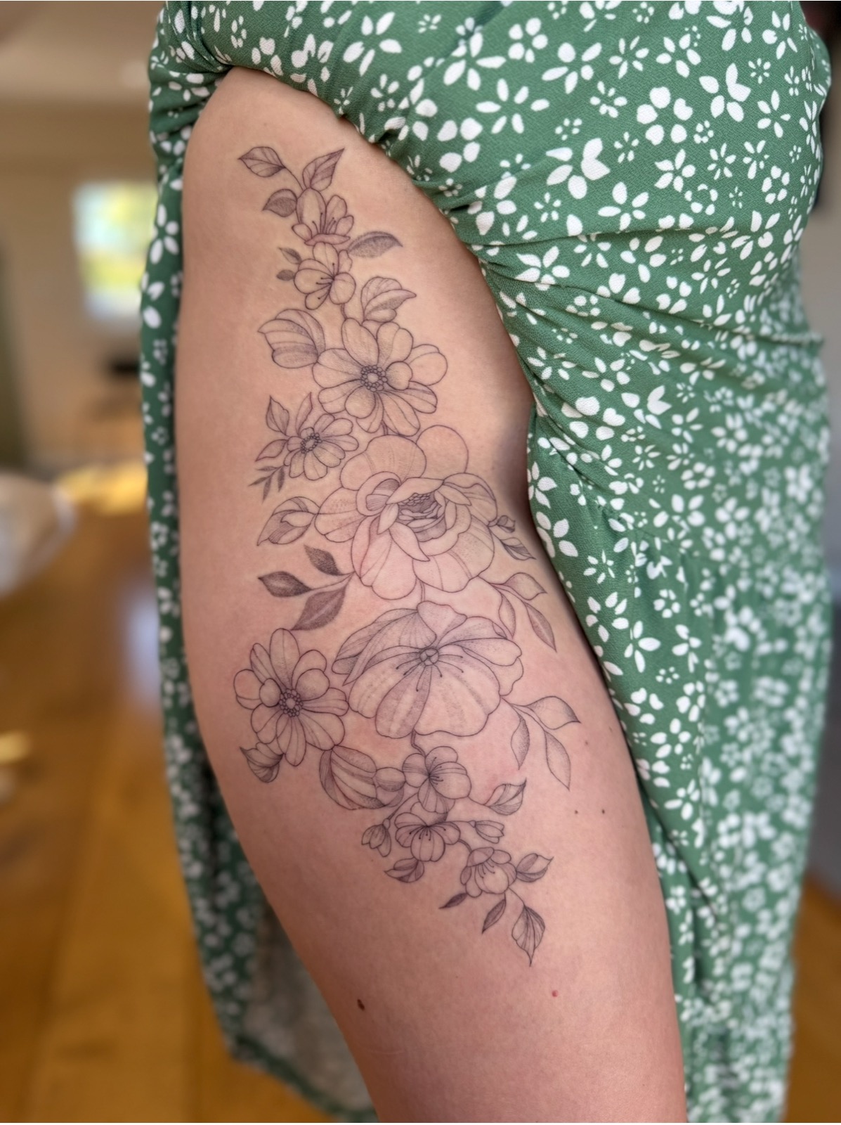 A fine line floral tattoo created at Petite Ink